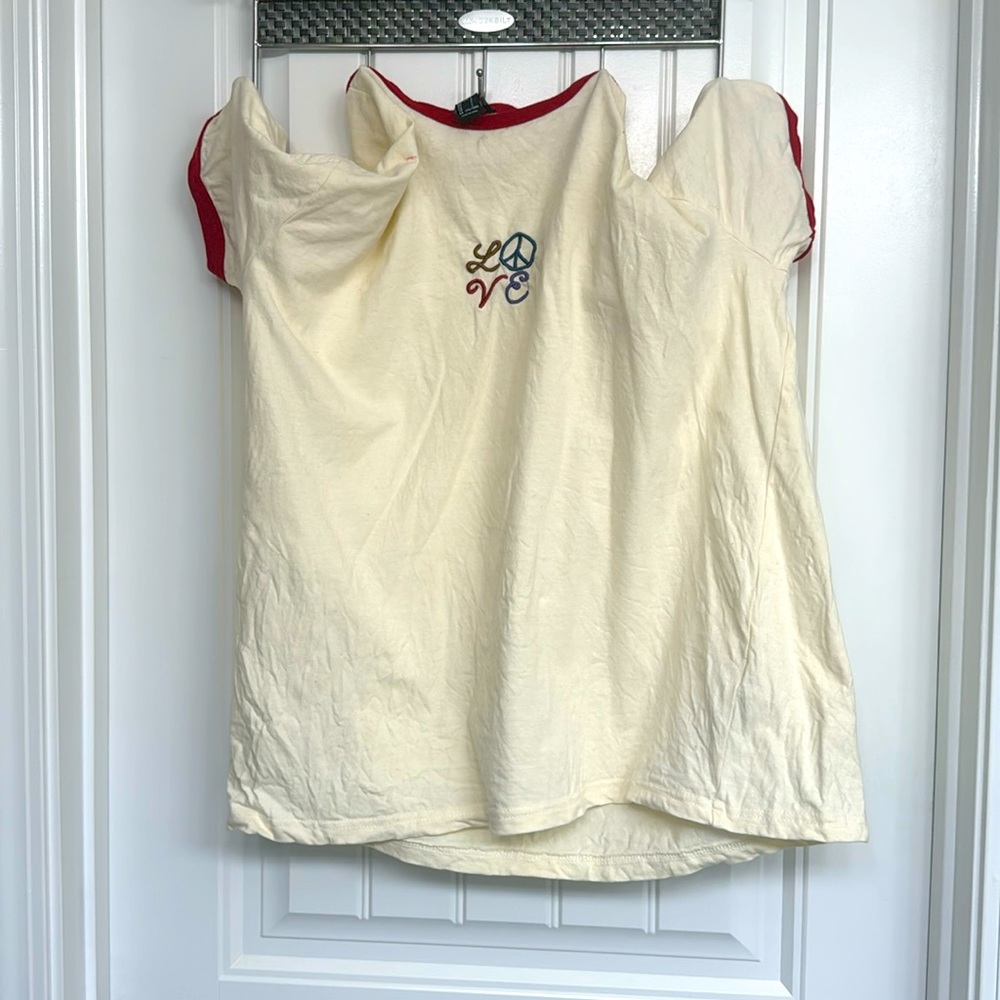 Selling crème love shirt.